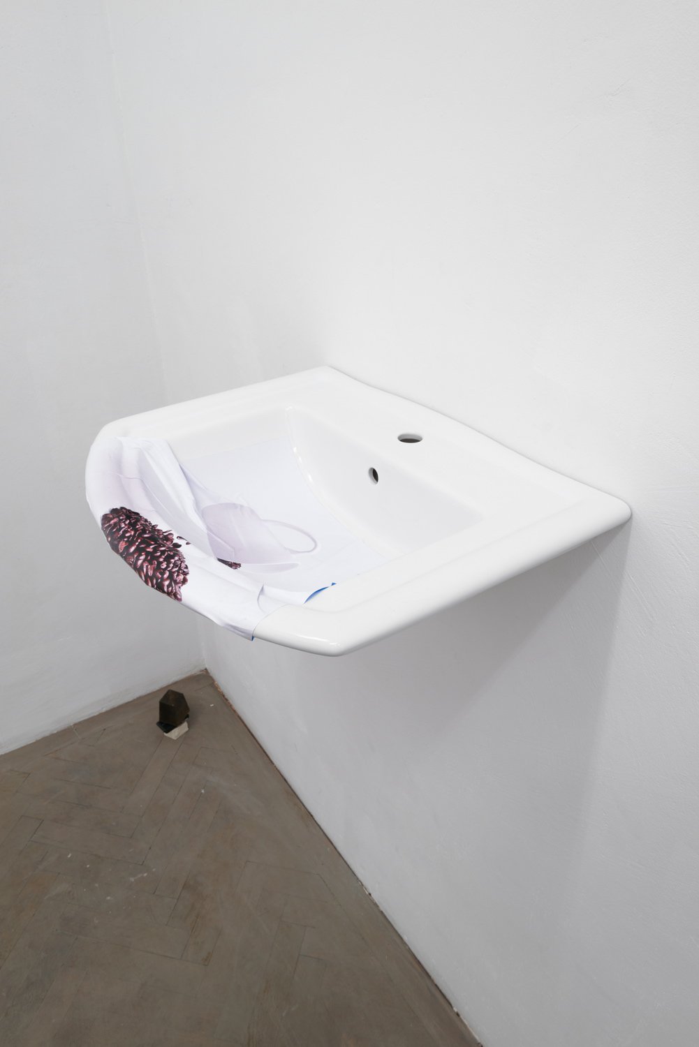 Nina BeierThe Demonstraters (Solid Coffee Spill), 2014Porcelain sink and paper51.5 x 66 x 21.3 cm
